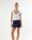 Model wearing a white fitted tee with a navy blue Notre Dame sequin mini skirt on a white background