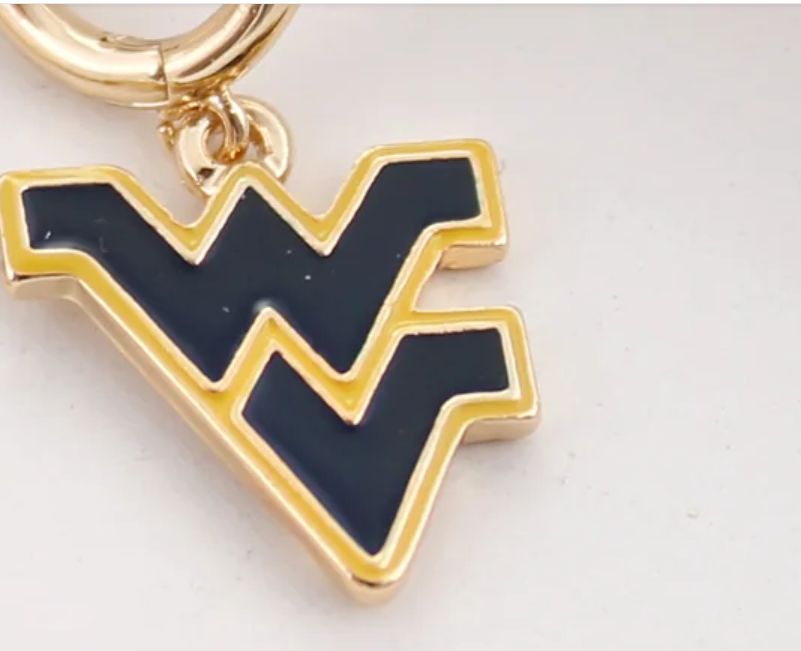 Close-up of a West Virginia Mountaineers navy and gold enamel WV logo charm on a gold-tone huggie hoop earring.