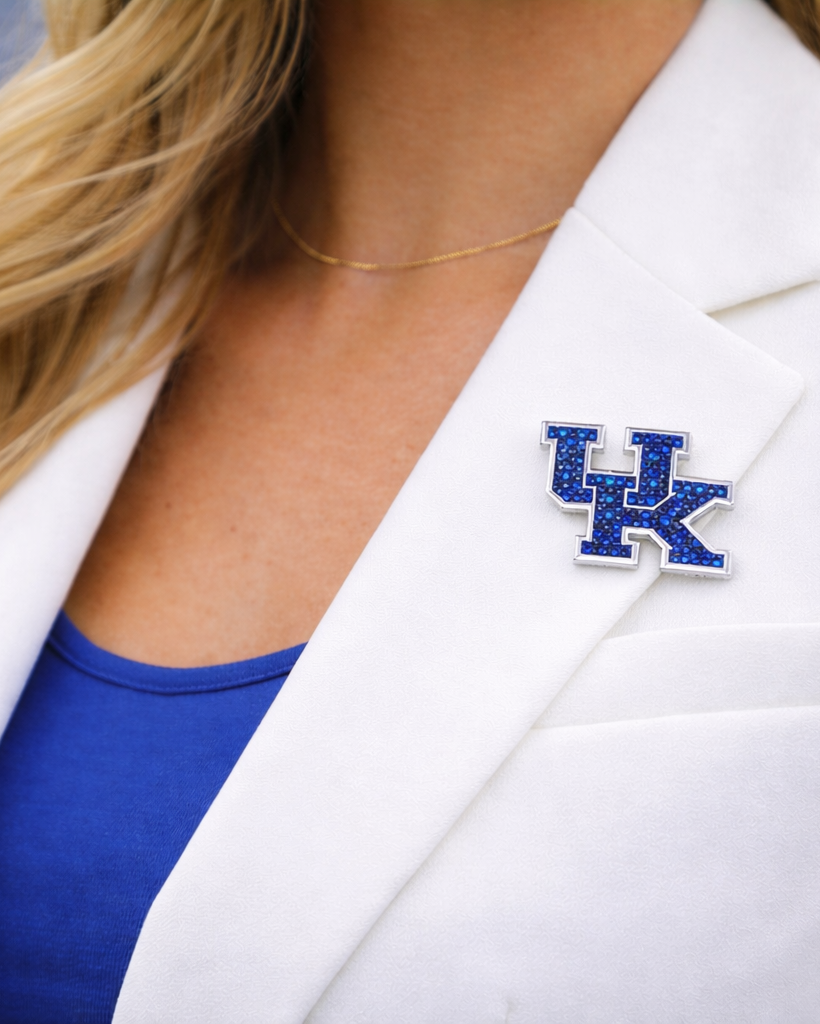 Person wearing a white blazer with a Kentucky Wildcats logo