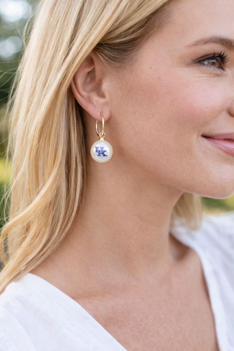 Kentucky UK pearl drop huggie earrings worn on model