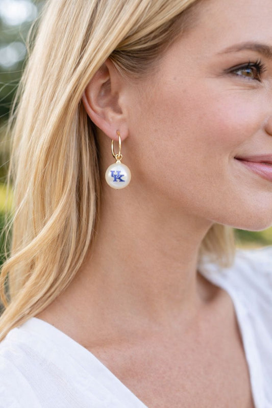 Kentucky UK pearl drop huggie earrings worn on model