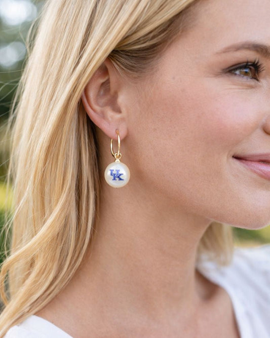 Kentucky UK pearl drop huggie earrings worn on model
