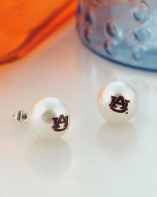 Auburn University AU logo pearl stud earrings with silver posts on white surface