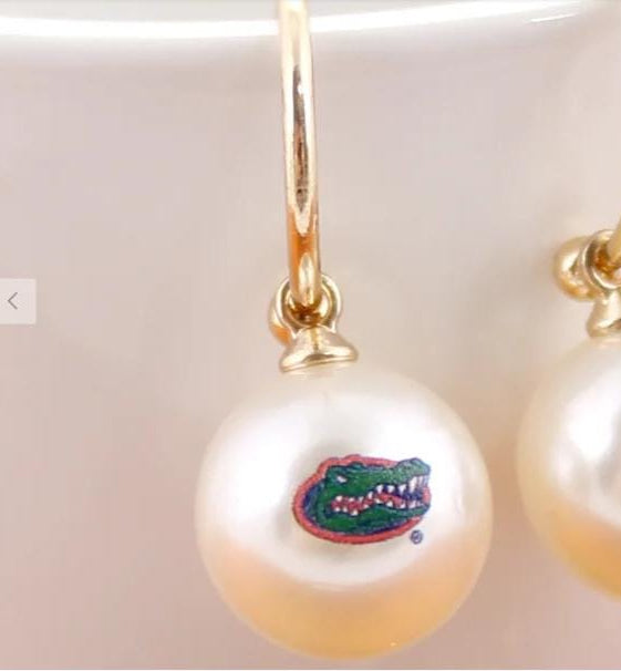 Close-up of Florida Gators logo pearl hoop earring with gold hoop