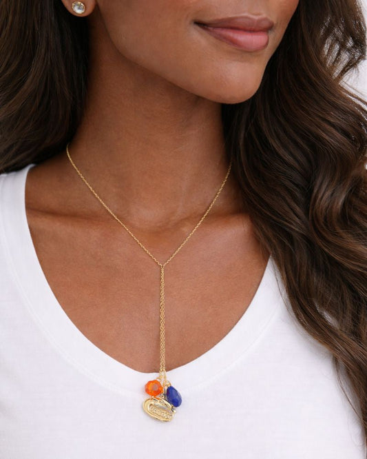 Model wearing Florida Gators gold Y-drop necklace with orange and blue crystals