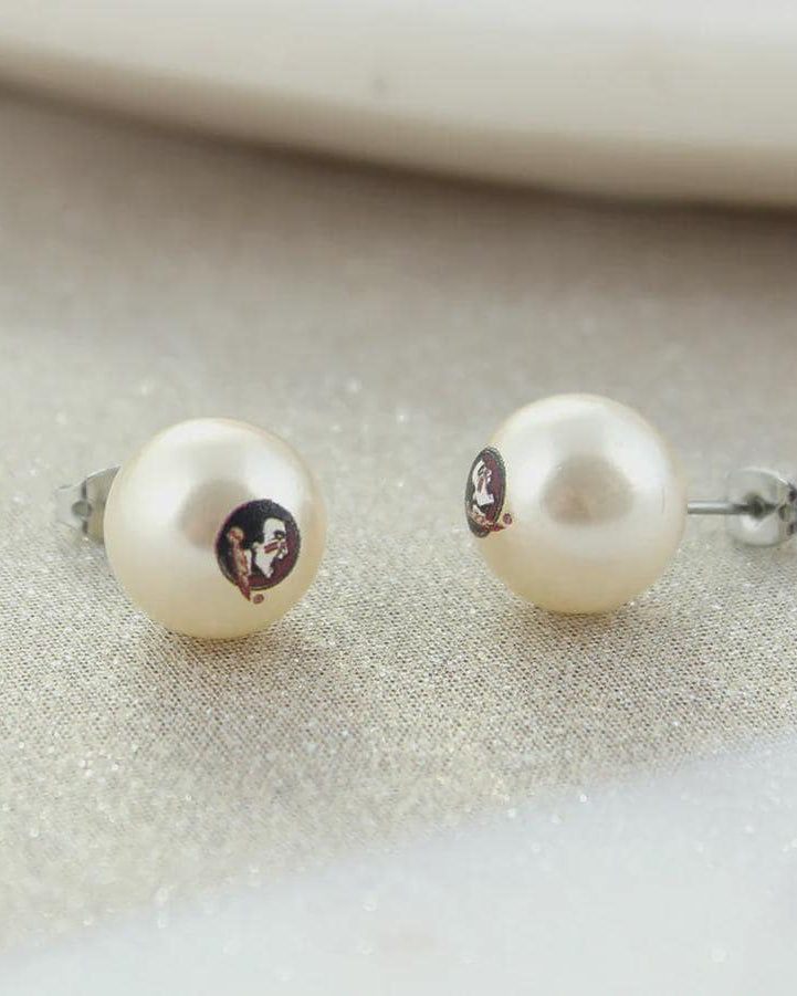 Florida State pearl stud earrings with logo on a neutral background