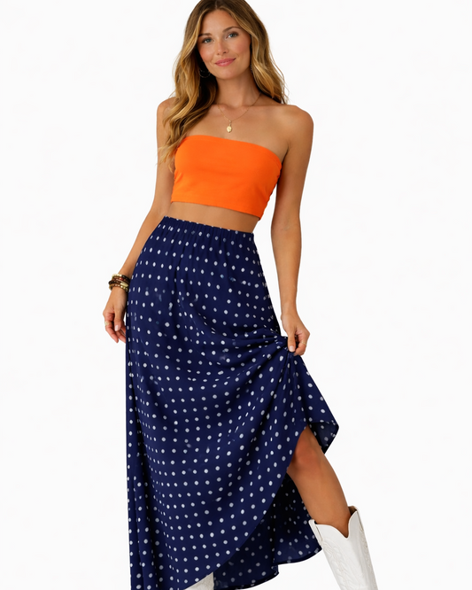 Royal blue polka dot maxi skirt with orange strapless crop top styled for game day outfit on white background