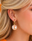 Model wearing Tennessee Vols pearl huggie earrings with orange Power T logo and gold hoops