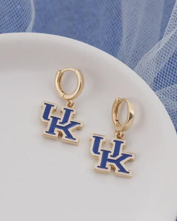 Gold University of Kentucky logo huggie earrings on a blue background