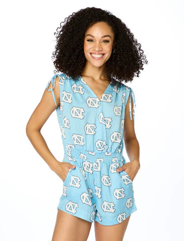 Model wearing UNC Tar Heels Carolina blue satin romper with allover logo print